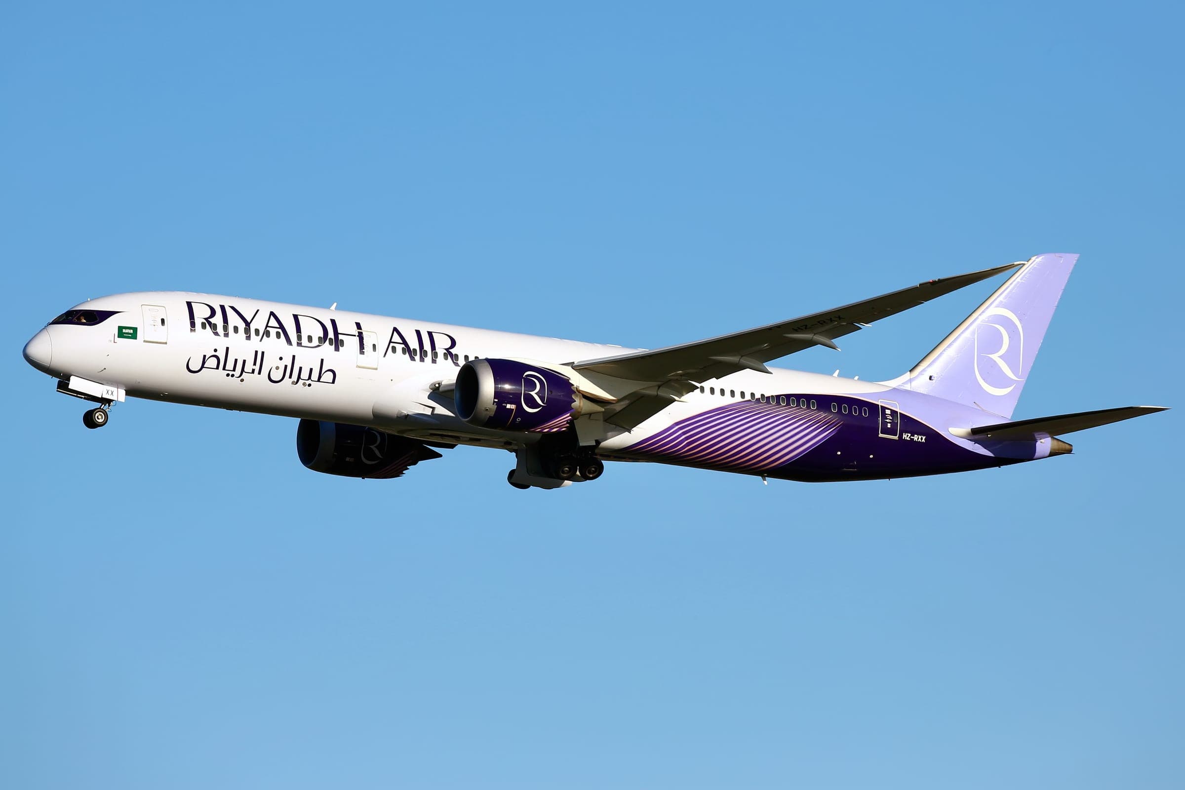 A Riyadh Air Boeing 787-9 Dreamliner climbing after departure in the airline's purple and white livery.
