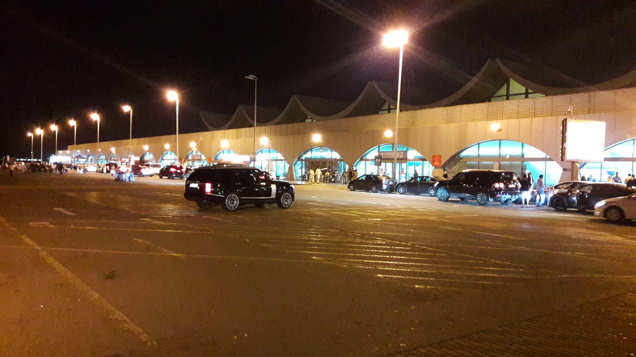 The forecourt of the North Terminal at King Abdulaziz International Airport, Jeddah, at night.